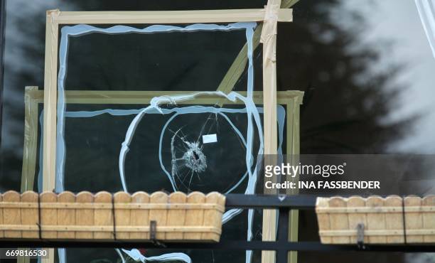 Damaged window with impacts caused by an explosion is seen at a house near the hotel L'Arrivee in Dortmund, western Germany on April 18 where the bus...