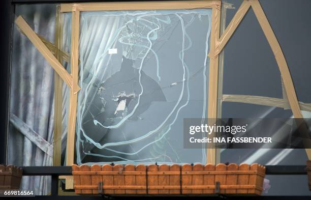 Damaged window with impacts caused by an explosion is seen at a house near the hotel L'Arrivee in Dortmund, western Germany on April 18 where the bus...