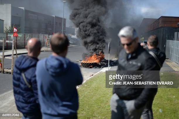 Tyres burn outside an incineration plant amid a strike by garbage collectors in Nantes, western France, on April 18, 2017. / AFP PHOTO /...