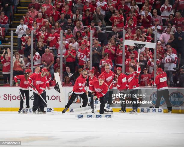 Former Detroit Red Wings Darren McCarty, Larry Murphy, Tomas Holmstrom and Dino Ciccarelli help shovel snow on a TV time out during the final home...