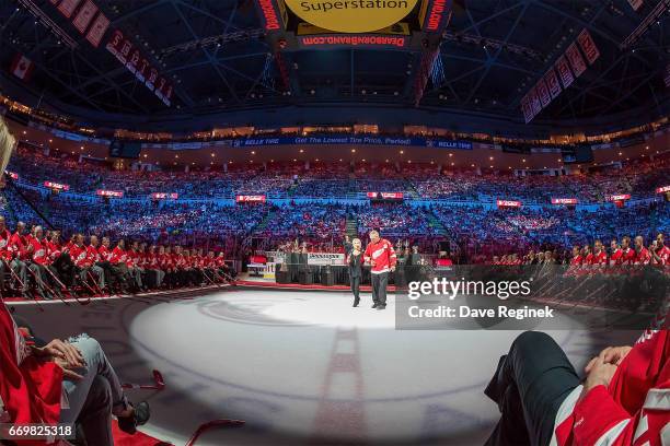 Former Detroit Red Wings Darren McCarty escorts singer Karen Newman to center ice during post game ceremonies after the final home game ever played...