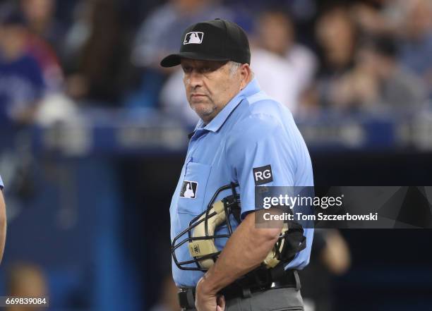 Home plate umpire Dale Scott looks on during the Toronto Blue Jays MLB game against the Baltimore Orioles at Rogers Centre on April 14, 2017 in...