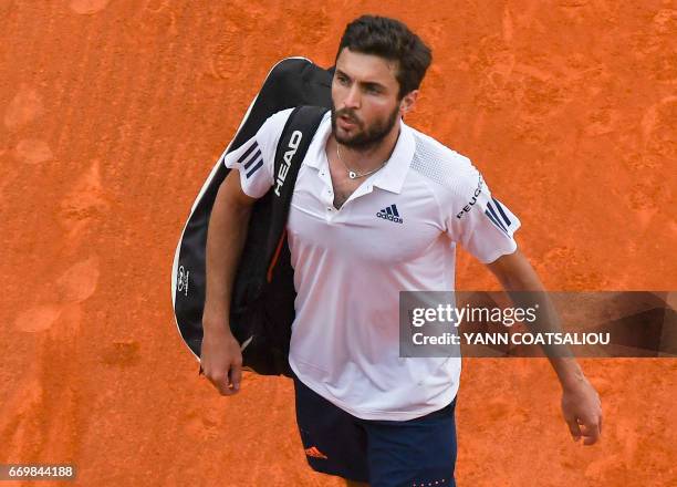 French's Gilles Simon leaves the pitch after his match against Serbia's Novak Djokovic during the Monte-Carlo ATP Masters Series tournament on April...