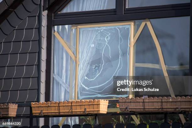 Broken windows are seen near the crime scene where the bus of the Borussia Dortmund football team was targeted in a bomb attack on April 11, on April...