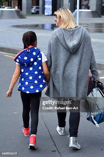 mother and child  walks down the street together - photohui stock pictures, royalty-free photos & images