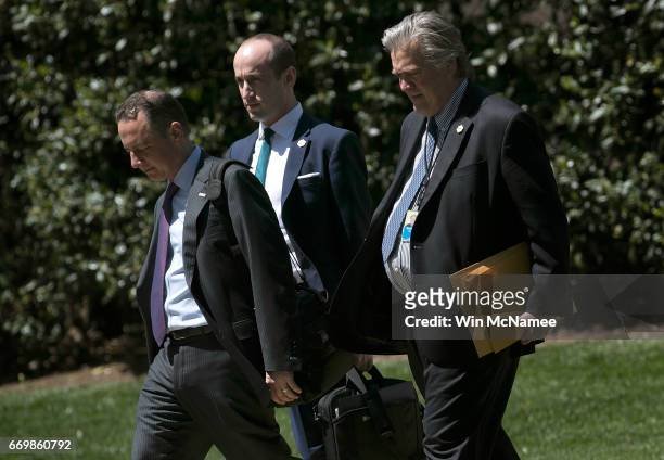 White House Chief of Staff Reince Priebus , chief political strategist Steve Bannon , and senior policital advisor Stephen Miller walk to a waiting...