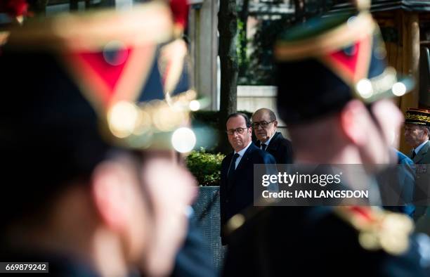 French President Francois Hollande and Defense Minister Jean-Yves Le Drian review troops as part of a ceremony for fallen French soldiers in overseas...