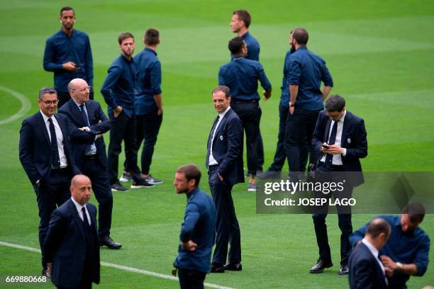 Juventus' coach Massimiliano Allegri and Juventus' team members stand on the field at the Camp Nou stadium in Barcelona on April 18, 2017 on the eve...