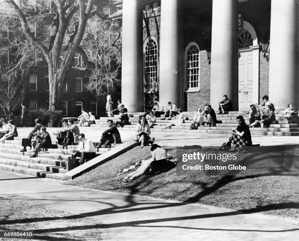 Students sit on the steps of Memorial Chapel at Harvard University on a sunny Mar. 26, 1963 in Cambridge, MA.