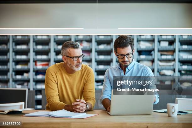 confident businessmen using laptop at desk - computer front view stock pictures, royalty-free photos & images