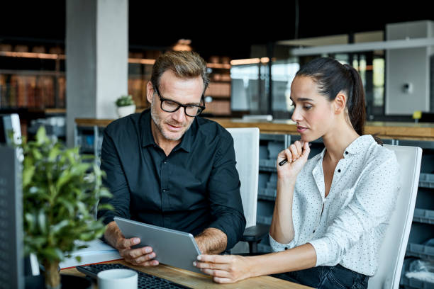 colleagues using tablet pc in textile factory - business finance and industry stock pictures, royalty-free photos & images