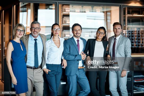 business people standing in row at textile factory - medium group of people stock pictures, royalty-free photos & images