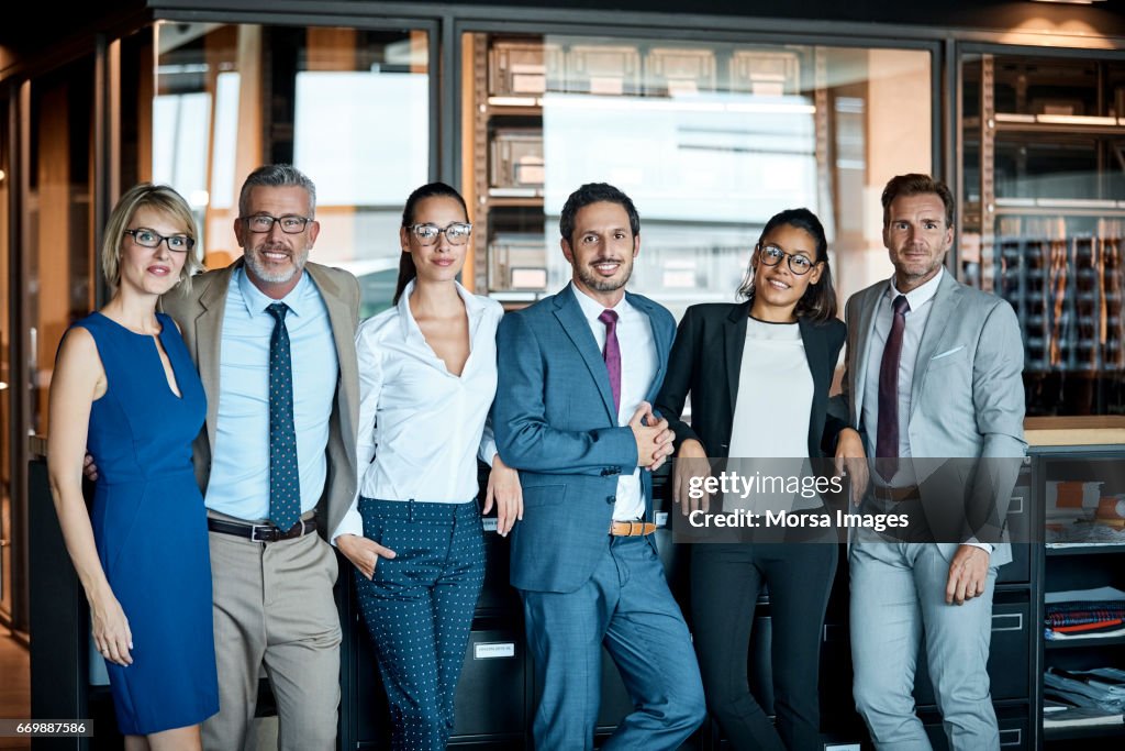 Business people standing in row at textile factory