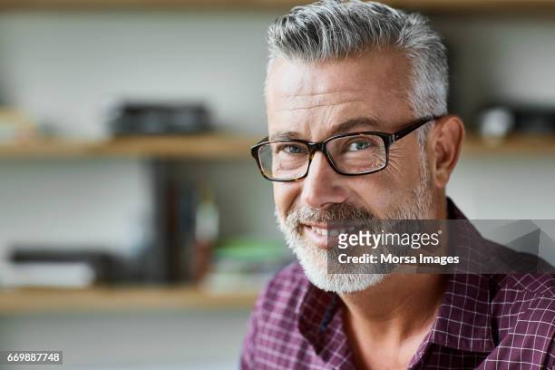 businessman smiling in textile factory - capelli grigi foto e immagini stock