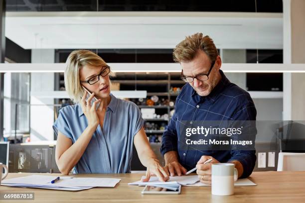 business people working at desk in textile factory - 40 44 years blond hair mature man factory stock pictures, royalty-free photos & images