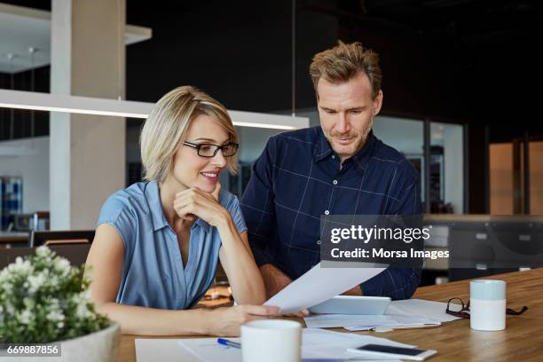 business people looking at document at desk - 40 44 years blond hair mature man factory stock pictures, royalty-free photos & images