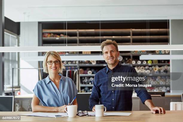 confident colleagues smiling in textile factory - 40 44 years blond hair mature man factory stock pictures, royalty-free photos & images