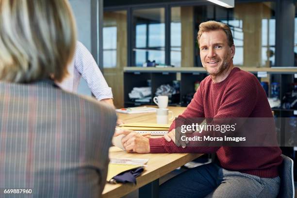 confident businessman smiling in textile factory - 40 44 years blond hair mature man factory stock pictures, royalty-free photos & images