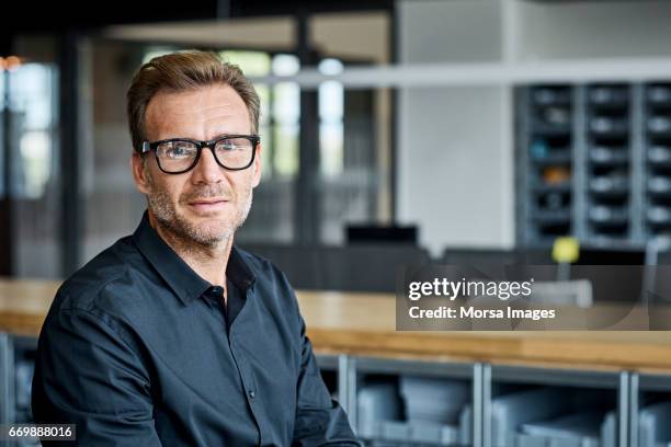 businessman wearing eyeglasses in textile factory - male blue eyes stock pictures, royalty-free photos & images