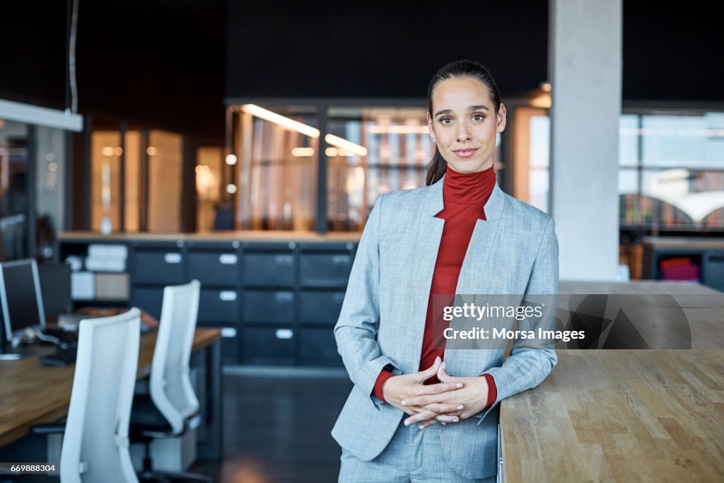 Confident female executive in textile factory
