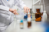 Female scientist making medicine in laboratory