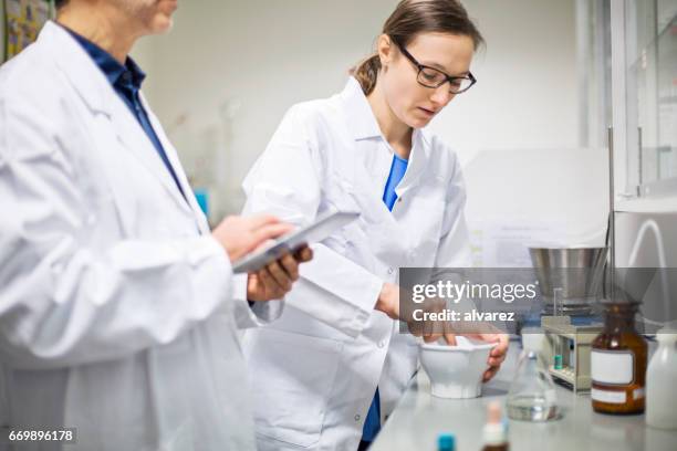 scientists making medicine at pharmacy - mortar and pestle stock pictures, royalty-free photos & images