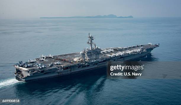 In this handout provided by the U.S. Navy, the aircraft carrier USS Carl Vinson transits the Sunda Strait on April 14, 2017 in Indonesia. The Carl...