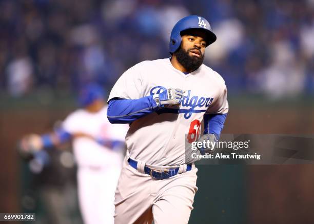 Andrew Toles of the Los Angeles Dodgers rounds the bases after hitting a home run in the first inning during the game against the Chicago Cubs at...