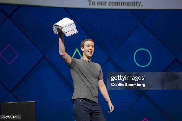 Mark Zuckerberg, chief executive officer and founder of Facebook Inc., holds up a stack of papers while speaking during the F8 Developers Conference...