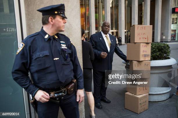 Security guard stands next to boxes of petitions left by protestors calling for the firing of Fox News television personality Bill O'Reilly in front...
