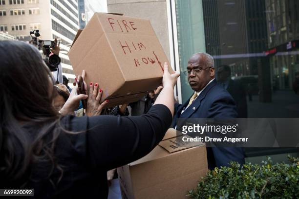 Demonstrators deliver boxes of petitions calling for the firing of Fox News television personality Bill O'Reilly to the front of the News Corp. And...