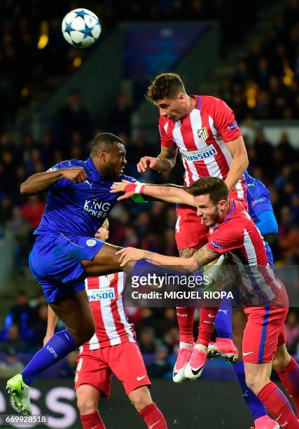 Leicester City's English-born Jamaican defender Wes Morgan vies with Atletico Madrid's Uruguayan defender Jose Maria Gimenez during the UEFA...