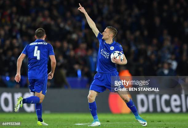 Leicester City's English striker Jamie Vardy celebrates scoring his team's first goal during the UEFA Champions League quarter-final second leg...