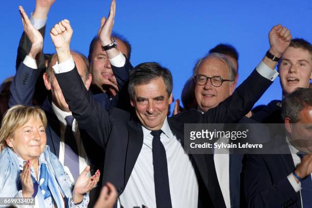 French presidential candidate Francois Fillon waves at the end of a rally party on April 18, 2017 in Lille, France. France will go to the polls on...