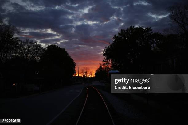 The sunrise reflects off CSX Corp. Train tracks in La Grange, Kentucky, U.S., on Tuesday, April 18, 2017. CSX Corp. Is scheduled to release earnings...