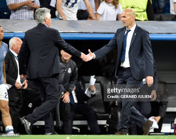 Bayern Munich's Italian head coach Carlo Ancelotti shakes hands with Real Madrid's French coach Zinedine Zidane after during the UEFA Champions...