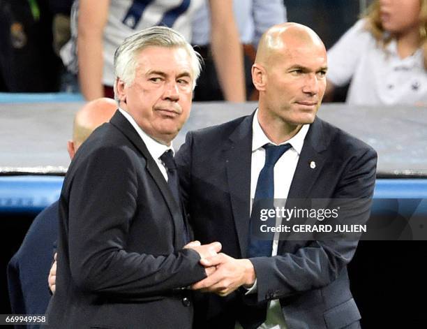 Bayern Munich's Italian head coach Carlo Ancelotti shakes hands with Real Madrid's French coach Zinedine Zidane after during the UEFA Champions...
