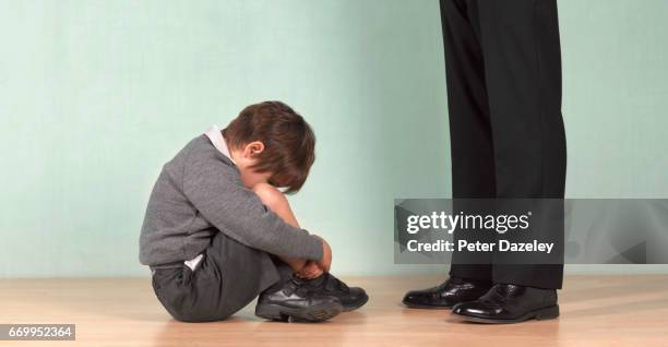 depressed school boy and teacher - child abuse stock-fotos und bilder