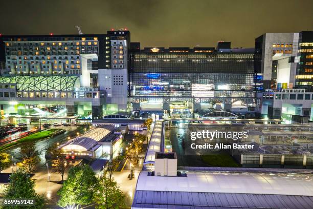 elevated view of kyoto main rail station illuminated at dusk - kyoto station stock pictures, royalty-free photos & images