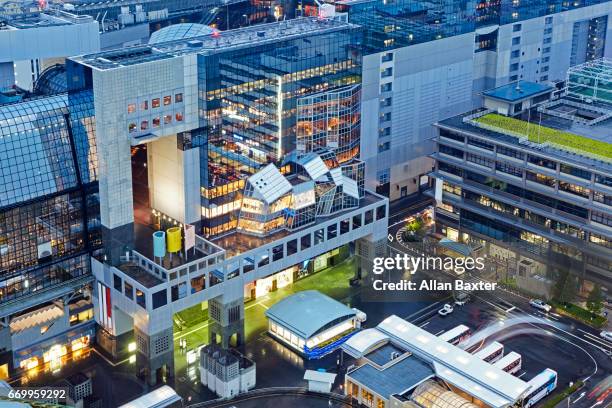 elevated view of kyoto main rail station illuminated at dusk - kyoto station stock pictures, royalty-free photos & images