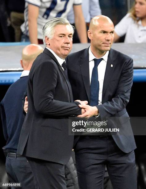 Bayern Munich's Italian head coach Carlo Ancelotti cheers Real Madrid's French coach Zinedine Zidane after the UEFA Champions League quarter-final...