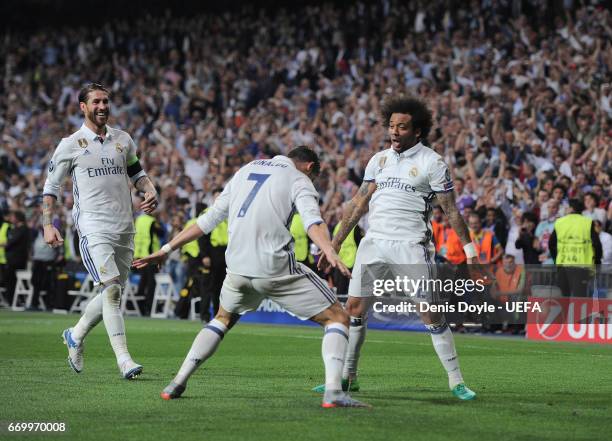 Cristiano Ronaldo of Real Madrid CF celebrates with Marcelo after scoring his 3rd goal during the UEFA Champions League Quarter Final second leg...