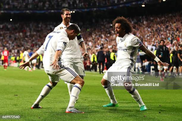 Cristiano Ronaldo of Real Madrid CF celebrates scoring his side's third goal with team-mate Marcelo during the UEFA Champions League Quarter Final...