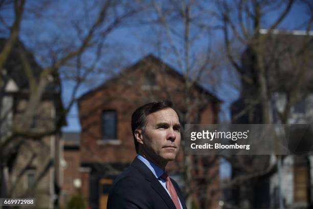 Bill Morneau, Canada's finance minister, listens during a press conference with John Tory, mayor of Toronto, and Charles Sousa, Ontario's finance...