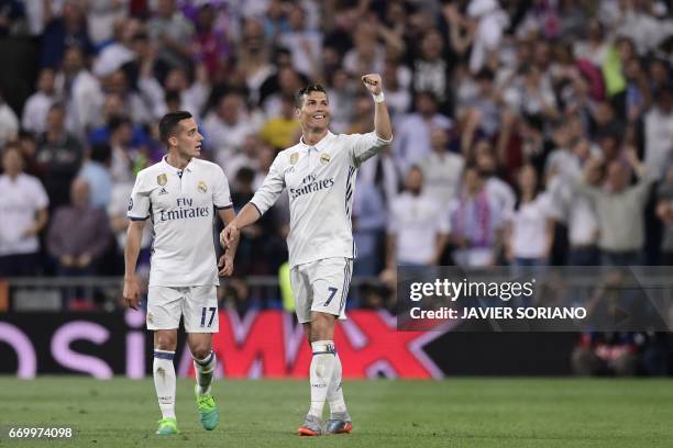 Real Madrid's midfielder Lucas Vazquez watches as Real Madrid's Portuguese forward Cristiano Ronaldo celebrates during the UEFA Champions League...