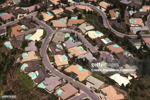 Daytime aerial view of the Hollywood large homes with pools with the Hollywood Hills area in April 1975 in Los Angeles.