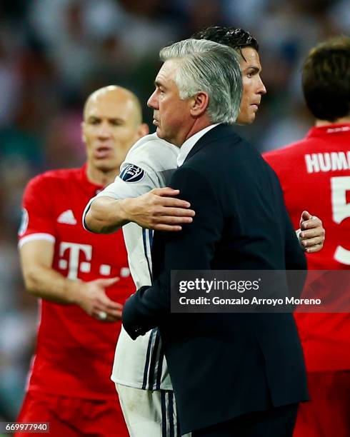 Cristiano Ronaldo of Real Madrid CF hugs head coach Carlo Ancelotti of Bayern Muenchen after the UEFA Champions League Quarter Final second leg match...