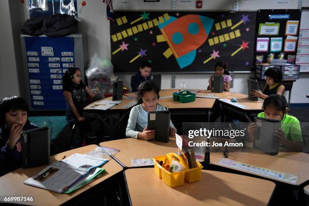 Year old Quiana Piper and her 3rd grade class study using their iPads and the Arapaho language app that has been created to help teach the language...