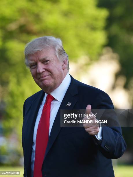 President Donald Trump makes his way across the South Lawn upon return to the White House in Washington, DC on April 18, 2017.