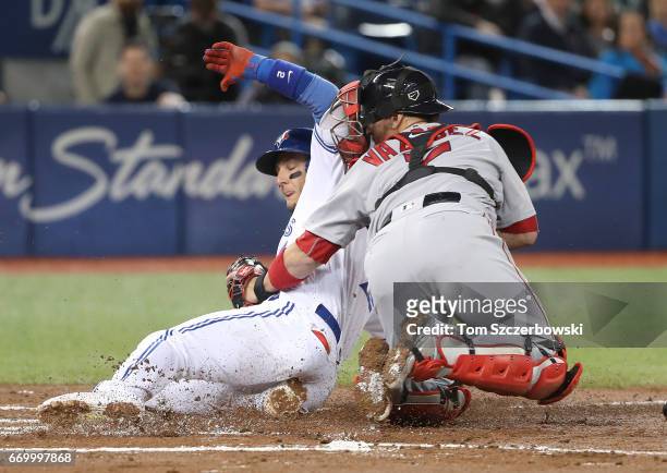 Troy Tulowitzki of the Toronto Blue Jays is thrown out at home plate in the first inning during MLB game action as Christian Vazquez of the Boston...